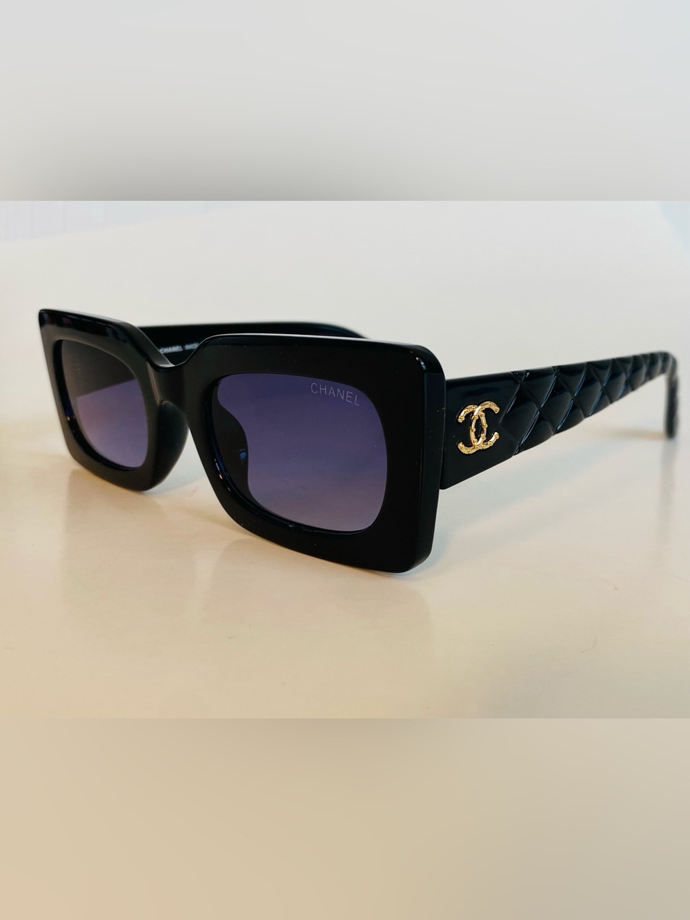 CHANEL Black Frame Sunglasses with Gradient Purple Lenses and Gold CC Temples